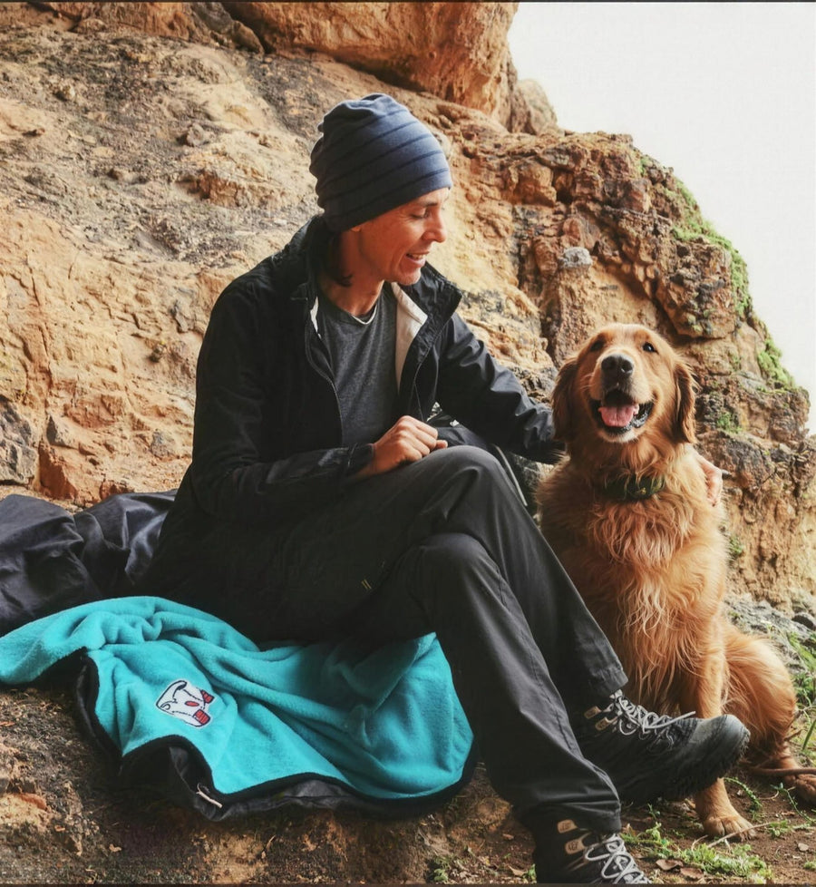 alcott adventure blanket on a coastal hike with golden retriever